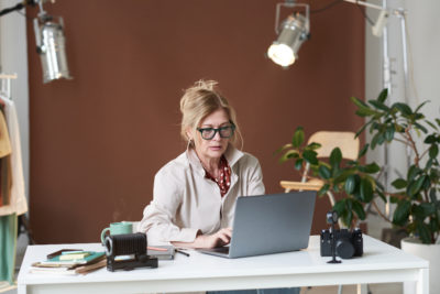 businesswoman typing on laptop real estate marketing strategies